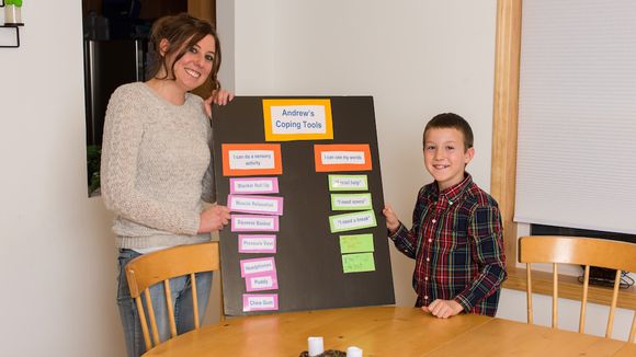 Child and staff with poster board