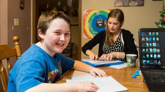 Child at table with staff